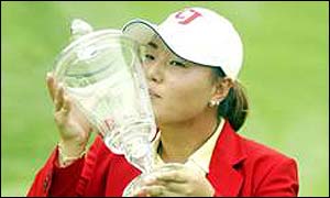 Gloria Park poses with the Big Apple Classic trophy