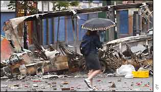 A passer-by made her way through the debris