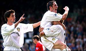 Robbie Keane celebrates a Leeds goal with Alan Smith and Harry Kewell (left)