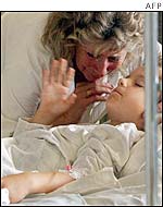 A boy is attended to by his grandmother at the reanimation department at the children's hospital in Lviv