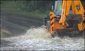 JCB going through water at Livingston