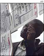 Kinshasa resident reading newspaper