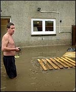 Man at flooded house