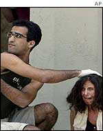 An injured woman is attended to by paramedics at the scene of the blast