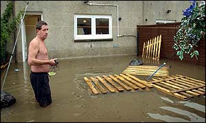Man in flooded garden in Shettleston, Glasgow