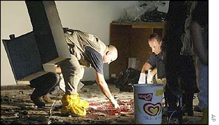 Police scour the inside of the cafeteria where the bombing took place
