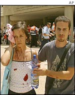 Injured woman is led away