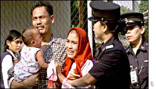 Police arrest a woman and her family outside a UN office 