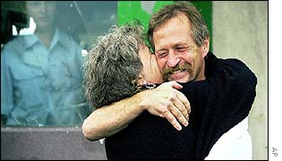 Jose Bove hugs his companion Ghislaine Ricez outside prison