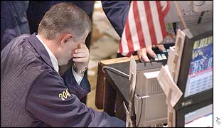 A trader rubs his eyes at his post on the floor of the New York Stock Exchange