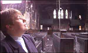 Reverend Liz Hughes surveys damage to church