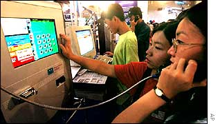 Chinese women use internet phone booth