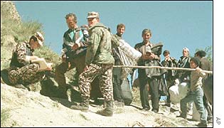 Georgian borderguards check documents of a group of Chechens at a border check-point