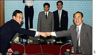 South Korean Lee Bong-jo (l) shakes hands with North Korean Choe Song-ik