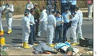 Workers near site of bus bombing