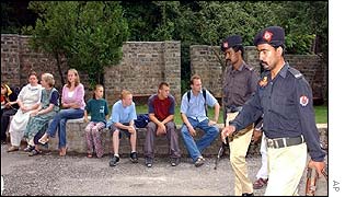 Pakistan police pass by the frightened foreign students