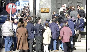 People queue outside a bank in Montevideo