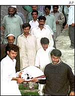 Rescue workers carry the body of one of those killed in the Murree attack