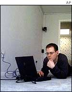 Man with laptop in empty room