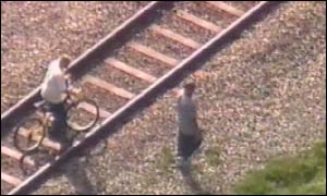 Children play on rail lines