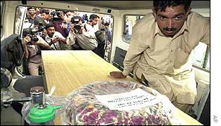 Coffin loaded on to ambulance