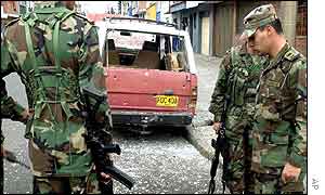 Soldiers inspect scene of one of the blasts