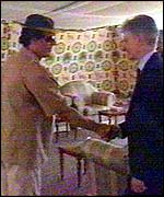 Colonel Muammar Gaddafi (l) greets UK Foreign Office Minister Mike O'Brien