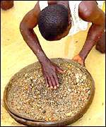 A man looks for diamonds in a river