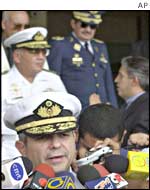 One of the four officers, Vice Adm. Daniel Comisso, speaks to the press