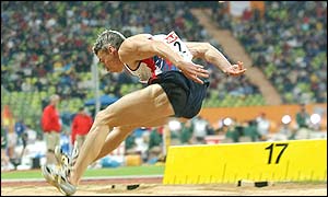 Jonathan Edwards soars to a big last jump but it is disallowed