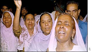 Relatives of grenade victim outside hospital in Taxila