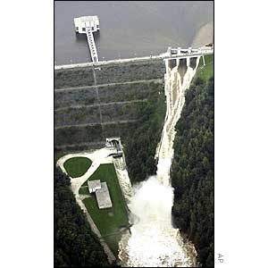 Water falls through the open floodgates of the Rimov dam on the Malse river, south Bohemia