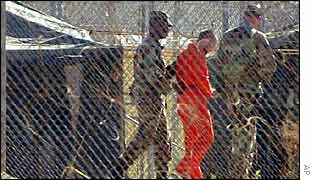 US soldiers escort an al-Qaeda suspect at Guantanamo Bay