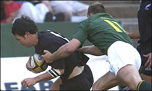 Leon MacDonald scores a try for New Zealand