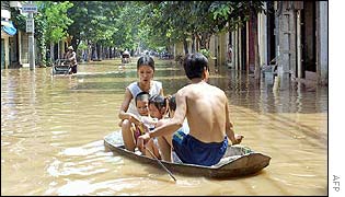 Family in flooded street in north Vietnam