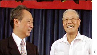 Former President Lee Teng-hui, right, smiles after delivering a speech at a political rally while Taiwan Solidarity Union chairman Huang Chu-wen looks on