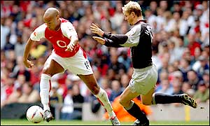 Stephane Henchoz tries to delay Thierry Henry as the striker flies down the wing