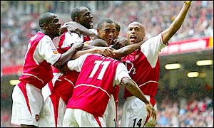 Gilberto Silva is mobbed by his team-mates after his 68th minute winner