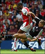 Steve Gerrard lunges in on Patrick Vieira to earn an early booking