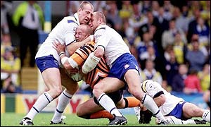 Castleford's Nathan Sykes is caught by Warringtons Nick Fozzard (left), Mark Hilton (centre) and Jon Clarke (right) 