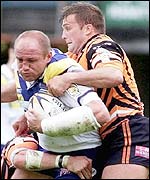 Mark Hilton's charge is halted by Castleford's Wayne Bartim (right) 