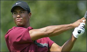 Tiger Woods punches an iron shot down the fairway