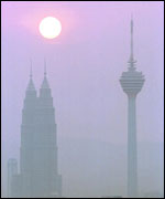 Sun, skyscrapers in haze AP