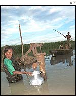 Woman gathers water in India