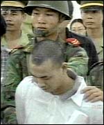 Soldiers hold a man sentenced to death for drug offences