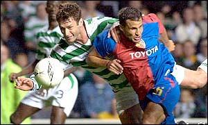 Chris Sutton wins an aerial challenge with Basel's Gregory Duruzduring at Celtic Park