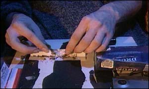 Smoker rolling cannabis joint