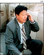 A Chinese man makes a call on a mobile phone