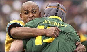 George Gregan of Australia and South Afrcia's Marius Joubert collide