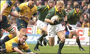 Brent Russell bursts through the Australian defence